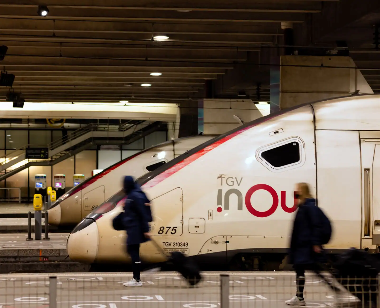 Rames de TGV INOUI à quai dans une gare parisienne, avec des voyageurs sur le quai.